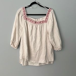 White blouse with red embroidered detail